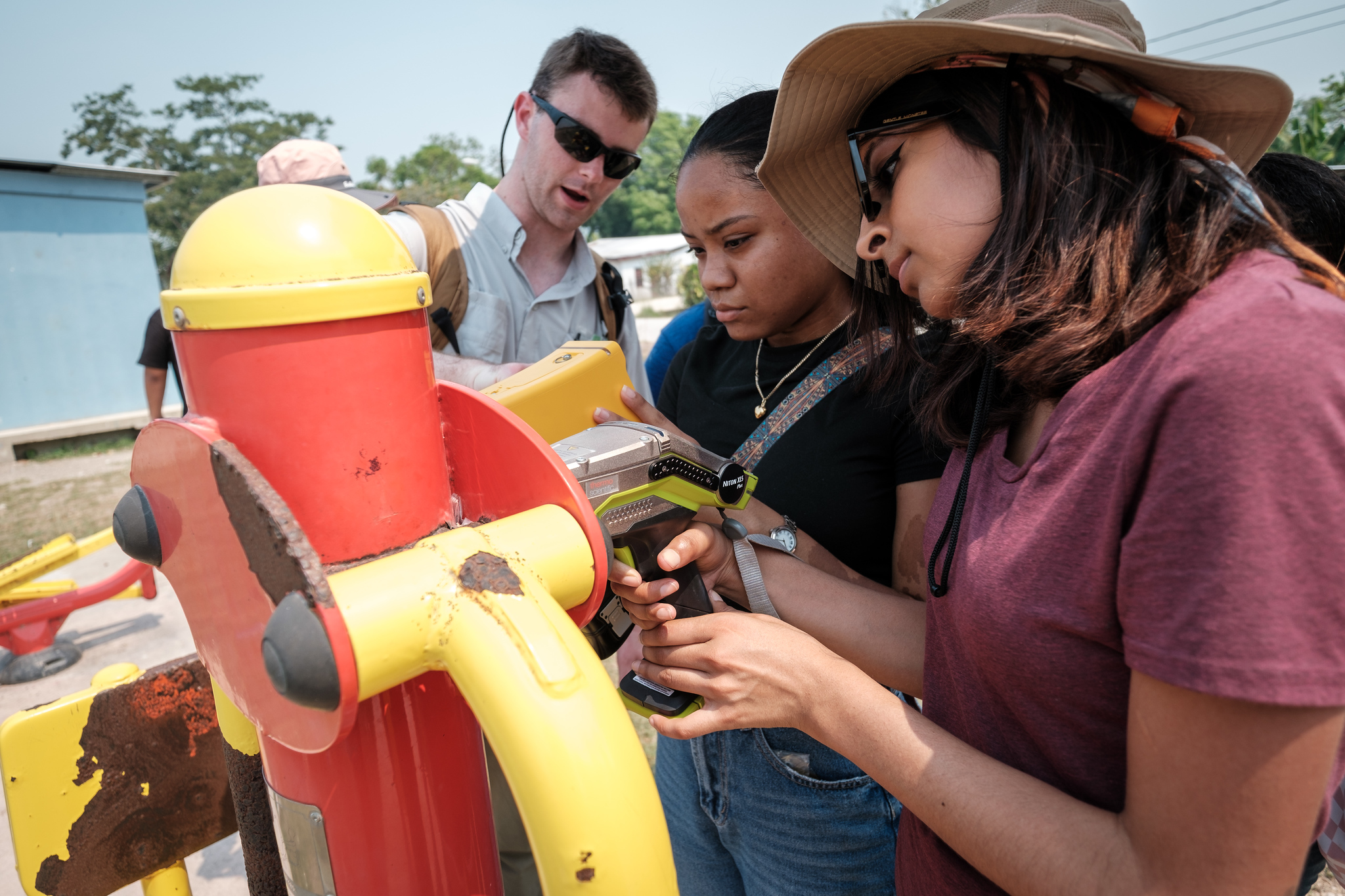 A team from Mercer University tests playground equipment in Belize for the presence of leaded paint.